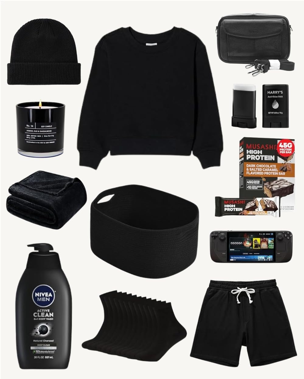 what-gifts-to-get-your-boyfriend-for-christmas-gamer An image showing a flat-lay collection of black and dark-colored gifts for a gamer or minimalist, all arranged on a white background. The items include: a black knit beanie, a burning black scented candle, a plain black crewneck sweatshirt, a black camera bag or shoulder sling, a black folding towel or blanket, a large black woven storage basket, a black tube of Harry's Anti-Chafe Stick, Musashi High Protein bars, a large bottle of Nivea Men Active Clean Body Wash, a stack of ten pairs of black socks, black athletic shorts with a white drawstring, and a portable Steam Deck gaming console.