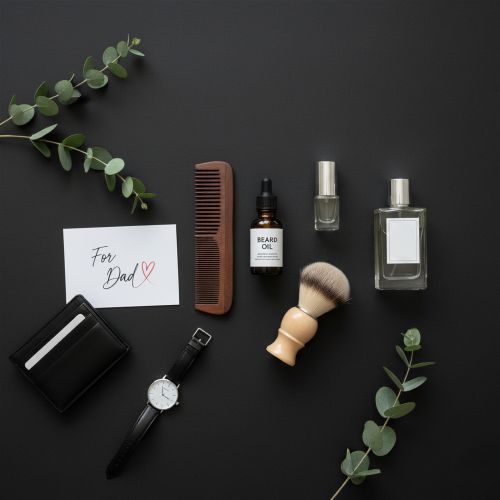 Flat lay image of Father's Day gifts on a dark background. Includes beard oil, wooden comb, perfume, watch, wallet, shaving brush, and a note saying "For Dad" with a heart.